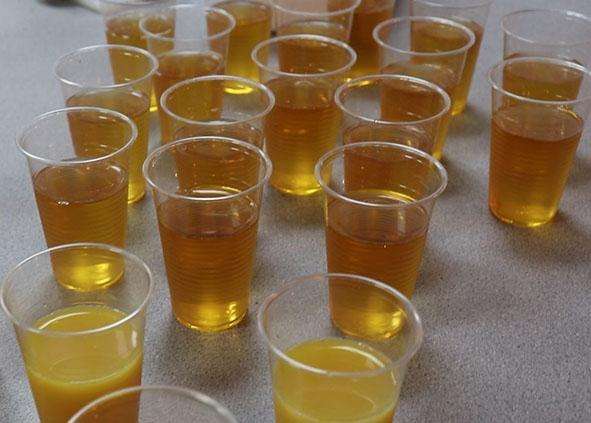 Plastic cups containing apple juice