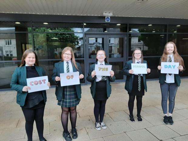 Group of secondary school aged children holding posters