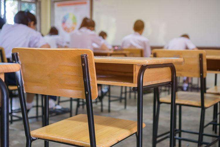 COSD back view of school desks and young people